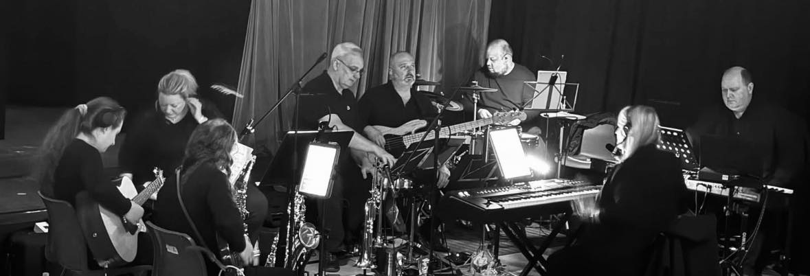 A black and white photograph of the pit band for the show Made in Dagenham